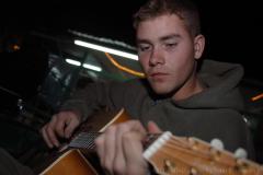CAMP TAQADDUM, Iraq -- Lance Cpl. Jeremiah K. Barr of King, N.C., a fiscal clerk currently serving his country with Quick Reaction Force, Provisional Rifle Company, Headquarters and Service Battalion, 2nd Marine Logistics Group (Forward), sings and plays the guitar here during his spare time. (Photo by Cpl. John E. Lawson Jr.)